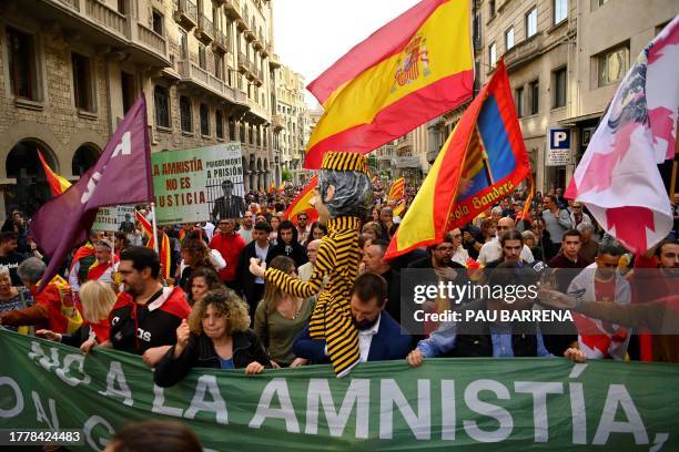 Demonstrators march during a protest called by right-wing opposition against an amnesty bill for people involved with Catalonia's failed 2017...