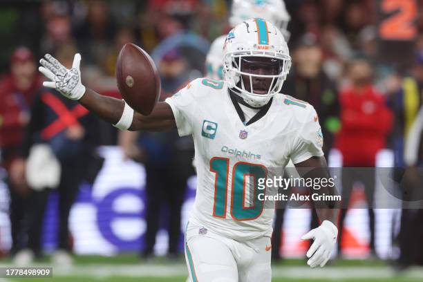 Tyreek Hill of the Miami Dolphins hands off the ball during the NFL match between Miami Dolphins and Kansas City Chiefs at Deutsche Bank Park on...
