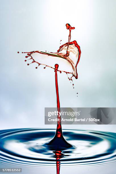 close-up of liquid splashing against white background - wasser splash fotografías e imágenes de stock