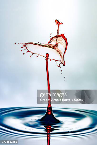 close-up of liquid splashing against white background - wasser splash stock pictures, royalty-free photos & images