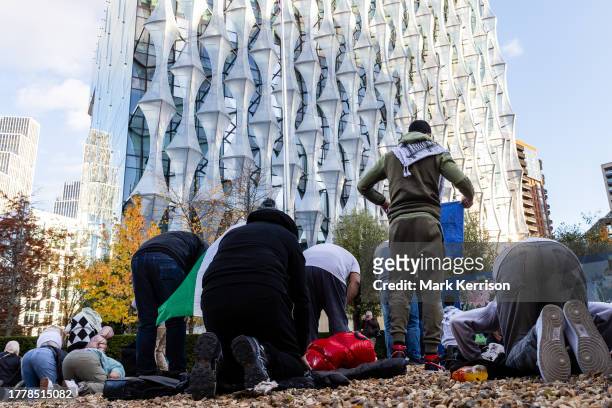 Pro-Palestinian protesters pray in front of the US embassy during an Armistice Day march to call for an immediate ceasefire in Gaza on 11th November...