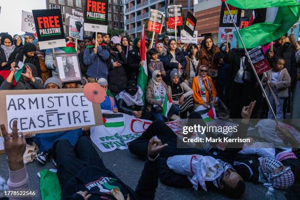 Pro-Palestinian protesters stage a die-in with mock baby corpses during an Armistice Day rally close to the US embassy to call for an immediate...