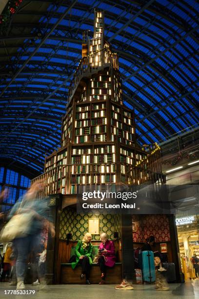 Large replica bookshelf in the shape of a Christmas tree is seen in Saint Pancras station on November 06, 2023 in London, England. The installation,...