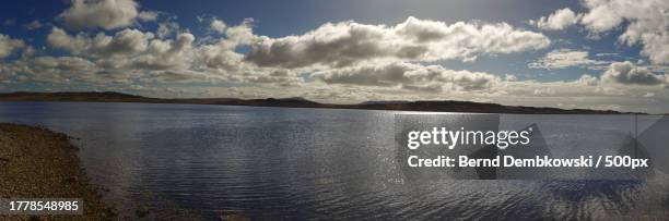 panoramic view of lake against sky - bernd dembkowski stock-fotos und bilder