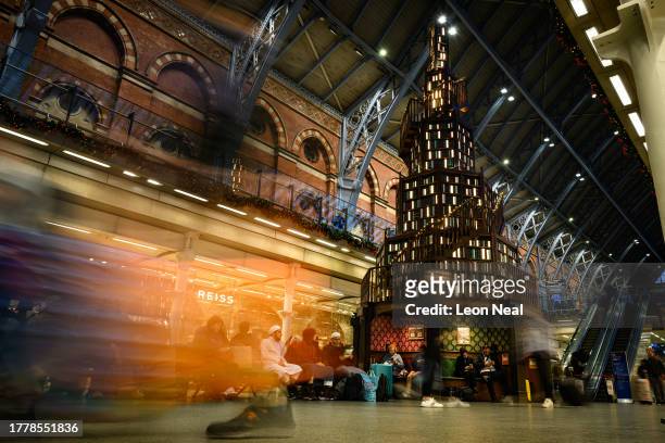 Large replica bookshelf in the shape of a Christmas tree is seen in Saint Pancras station on November 06, 2023 in London, England. The installation,...