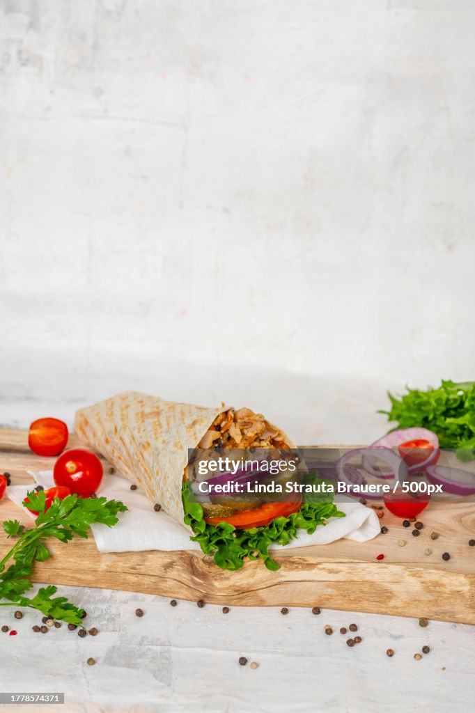 Close-up of food on cutting board against wall