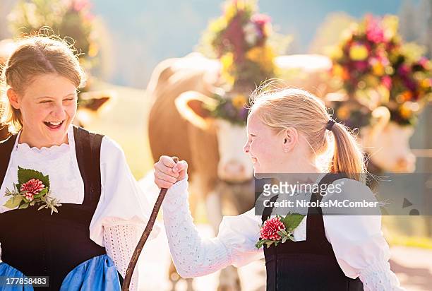 two swiss farmer girls having fun during aelplerfest parade - bernese alps stock pictures, royalty-free photos & images