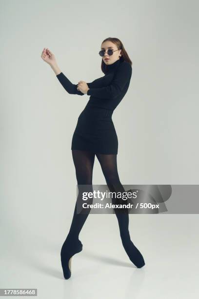 portrait of young woman dancing against white background,novosibirsk,siberia,russia - models in stockings stock pictures, royalty-free photos & images