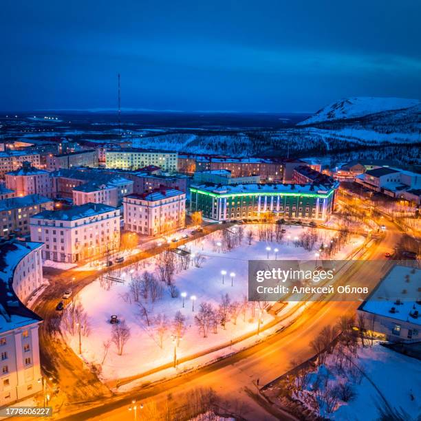 night citycape of kirovsk. houses in evening illumination. polar city in winter. (kirovsk, russia, murmansk oblast, kola peninsula, known as khibinogorsk, cold winter weather) - murmansk stock pictures, royalty-free photos & images