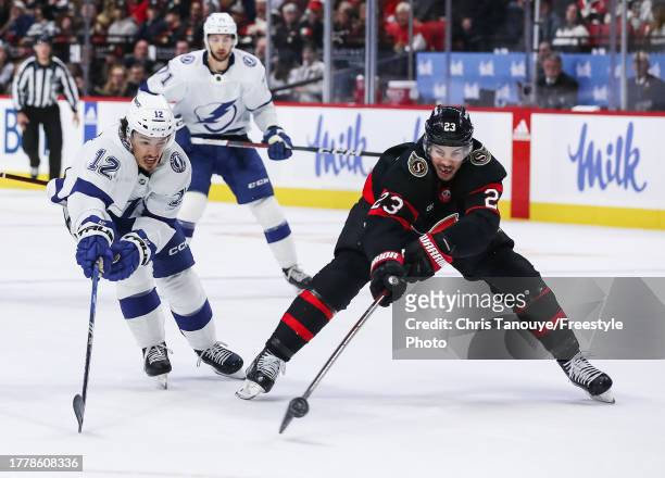 Alex Barre-Boulet of the Tampa Bay Lightning battles for the puck with Travis Hamonic of the Ottawa Senators at Canadian Tire Centre on November 04,...
