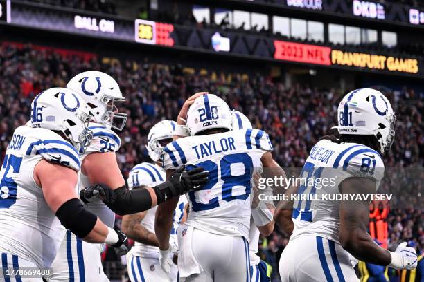 Indianapolis Colts' running back Jonathan Taylor celebrates scoring with his team-mates during the NFL American football match Indianapolis Colts vs...
