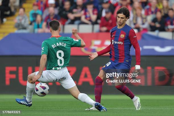 Barcelona's Portuguese forward Joao Felix vies with Alaves' Spanish defender Antonio Blanco during the Spanish league football match between FC...