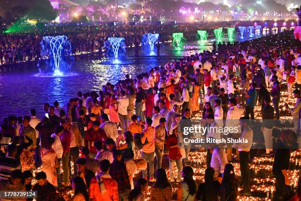 People light earthen lamps on the banks of Saryu River during a cultural programme, on the eve of Diwali festival, on November 11 Ayodhya, India....