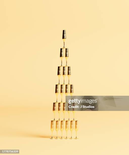 champagne pyramid of gold glasses - champagne pyramid stock pictures, royalty-free photos & images