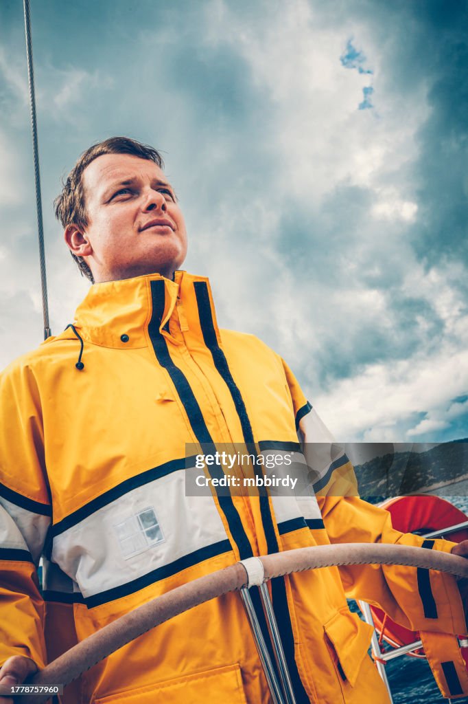Skipper sailing on sailboat