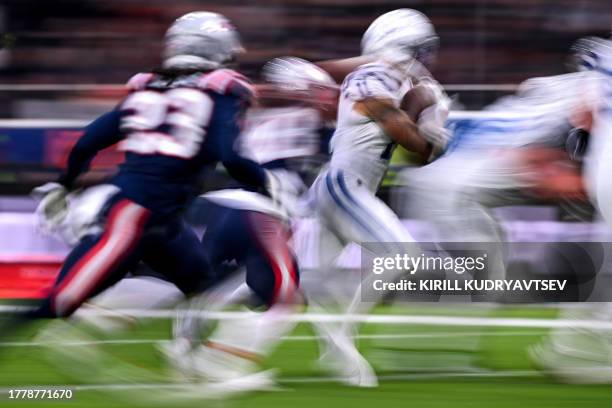 Indianapolis Colts' wide receiver Michael Pittman Jr. Runs with the ball past New England Patriots' cornerback Kyle Dugger during the NFL American...