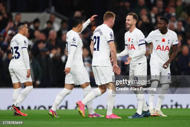 Dejan Kulusevski of Tottenham Hotspur celebrates with teammate James Maddison after scoring the team's first goal during the Premier League match...