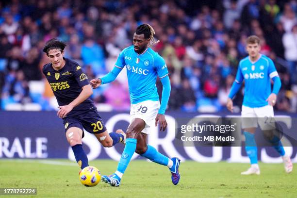 Andre-Frank Zambo Anguissa of SSC Napoli competes for the ball with Matteo Cancellieri of Empoli FC ,during the Serie A TIM match between SSC Napoli...