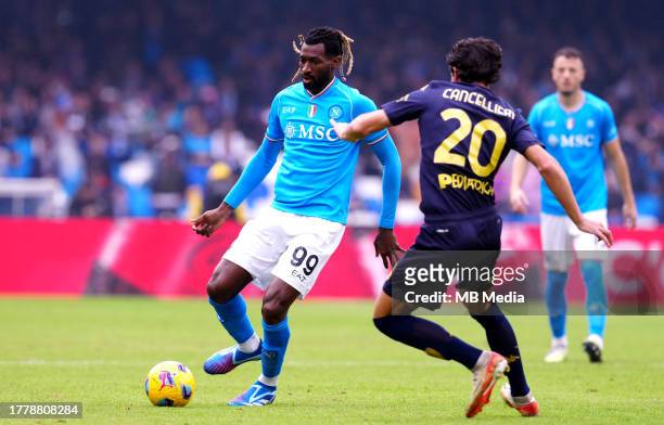 Andre-Frank Zambo Anguissa of SSC Napoli competes for the ball with Matteo Cancellieri of Empoli FC ,during the Serie A TIM match between SSC Napoli...