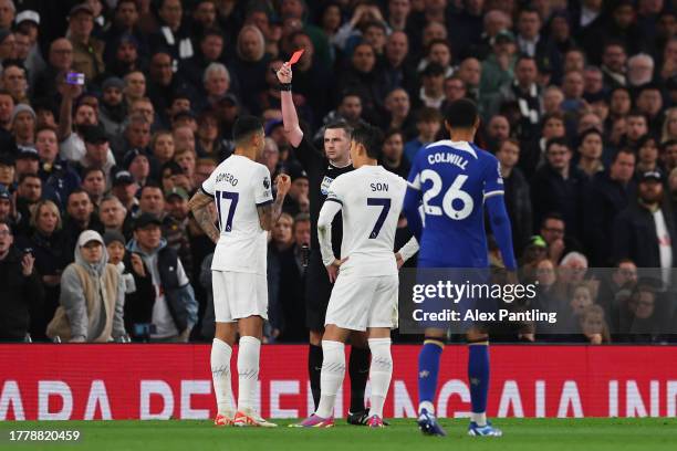 Referee Michael Oliver shows a red card to Cristian Romero of Tottenham Hotspur during the Premier League match between Tottenham Hotspur and Chelsea...