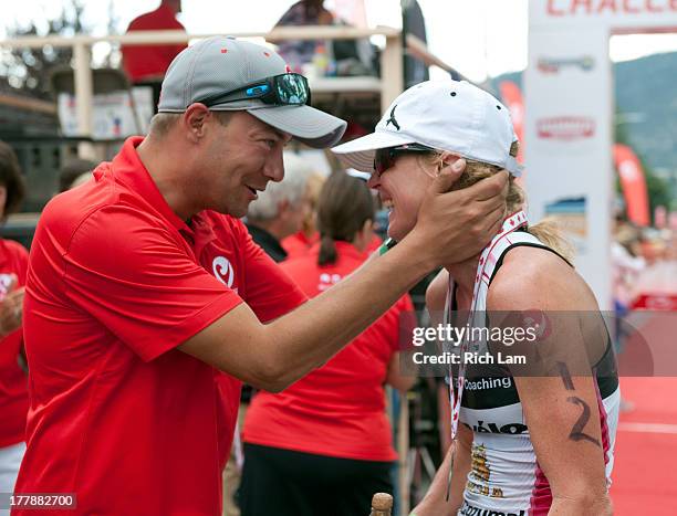 Carrie Lester is congratulated by Challenge Family CEO Felix Walchshofer after winning the women's division of the Challenge Penticton Triathlon on...