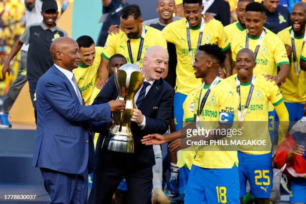 President of FIFA Gianni Infantino and President of the Confederation of African Football Patrice Motsepe hands over the trophy to Sundowns' South...