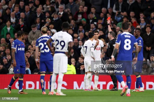 Referee Michael Oliver shows a red card to Cristian Romero of Tottenham Hotspur during the Premier League match between Tottenham Hotspur and Chelsea...