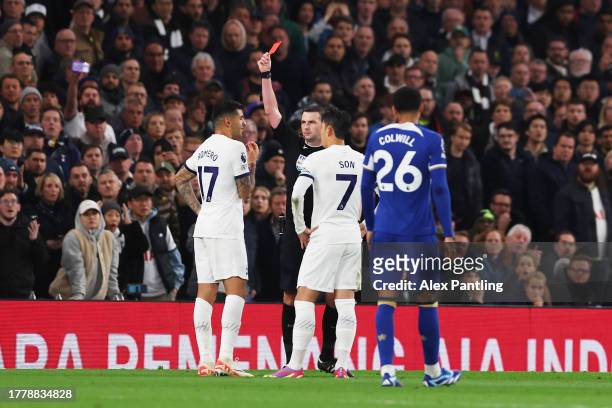 Referee Michael Oliver shows a red card to Cristian Romero of Tottenham Hotspur during the Premier League match between Tottenham Hotspur and Chelsea...