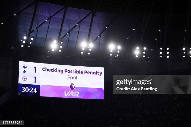 The LED board shows the VAR check for a possible penalty after a foul by Cristian Romero of Tottenham Hotspur which results in a penalty and a red...