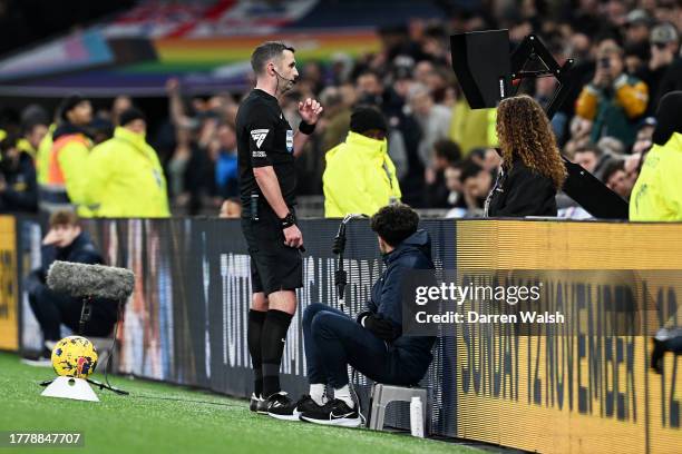 Referee Michael Oliver checks the VAR screen during the Premier League match between Tottenham Hotspur and Chelsea FC at Tottenham Hotspur Stadium on...