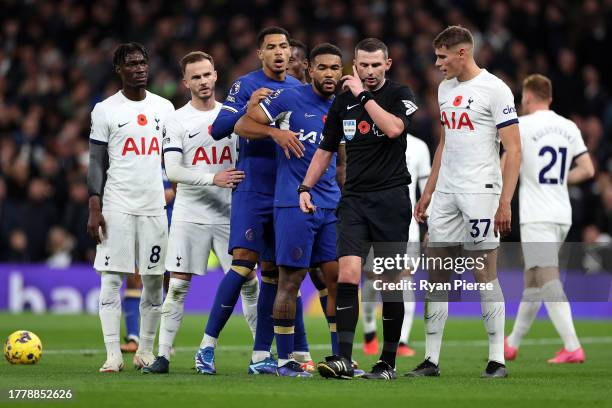 Referee Michael Oliver checks with VAR before a goal by Raheem Sterling of Chelsea is ruled out for handball during the Premier League match between...