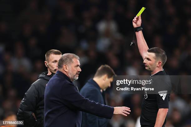 Referee Michael Oliver shows a yellow card to Ange Postecoglou, Manager of Tottenham Hotspur, during the Premier League match between Tottenham...