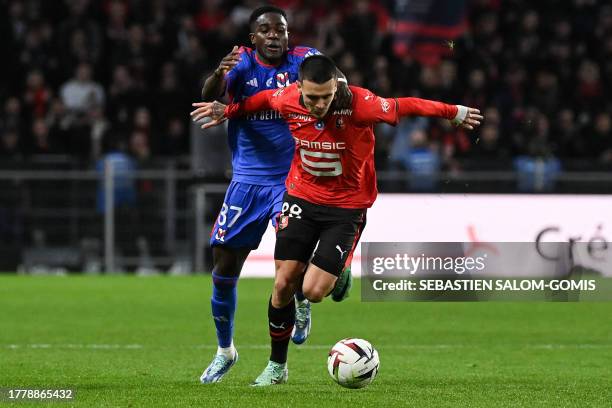 Lyon's Ghanaian forward Ernest Nuamah fights for the ball with Rennes' French midfielder Enzo Le Fee during the French L1 football match between...