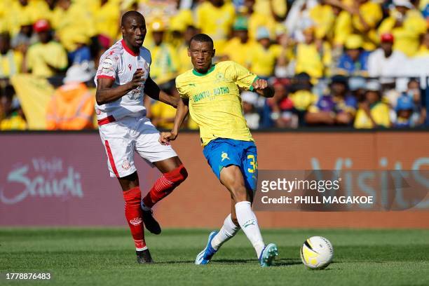 Sundowns' South African midfielder Mothobi Mvala kicks the ball away from Wydad's Soufyan Ahannach during the African Football League second-leg...