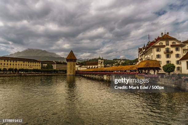 view of bridge over river against cloudy sky - church tower restoration appeal stock pictures, royalty-free photos & images