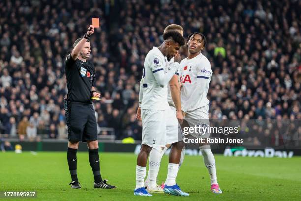 Referee Michael Oliver shows Destiny Udogie of Tottenham Hotspur his second yellow card followed by a red and sends him off during the Premier League...