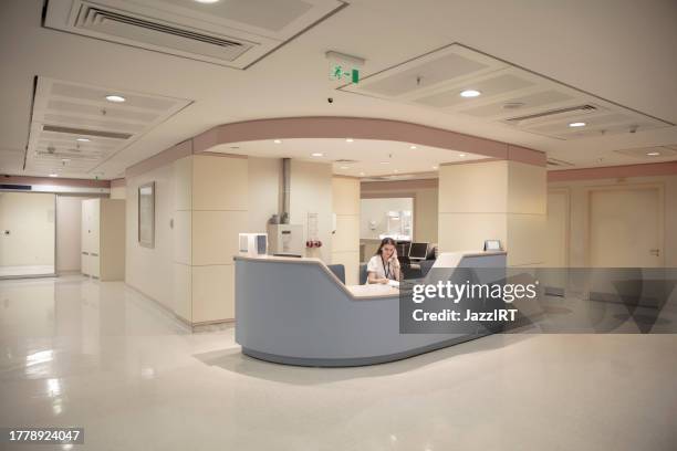 nurse information desk. maternity department of a modern hospital. waiting area. modern architecture. stylish and elegant. nurse working from the counter. - one empty desk stock pictures, royalty-free photos & images