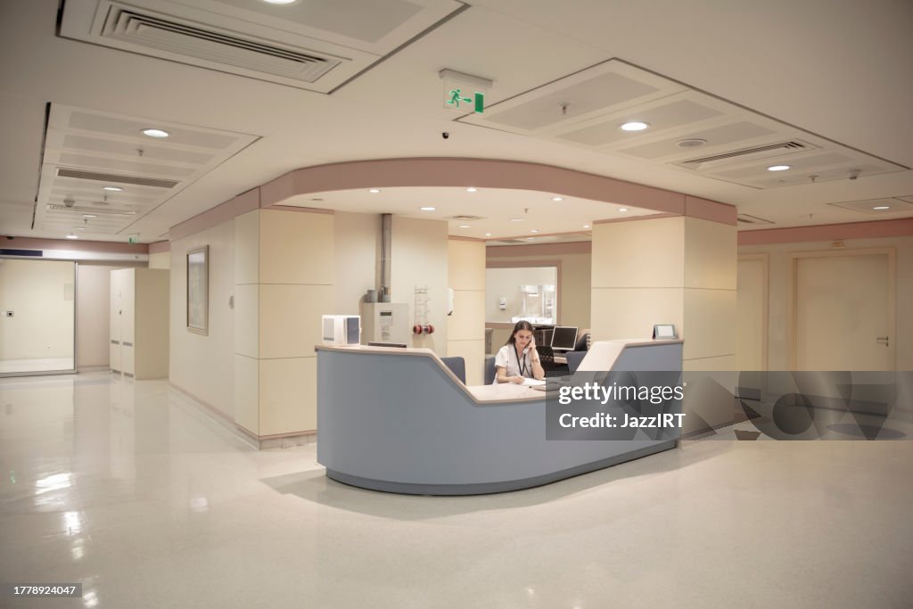 Nurse information desk. Maternity department of a modern hospital. Waiting area. Modern architecture. Stylish and elegant. Nurse working from the counter.
