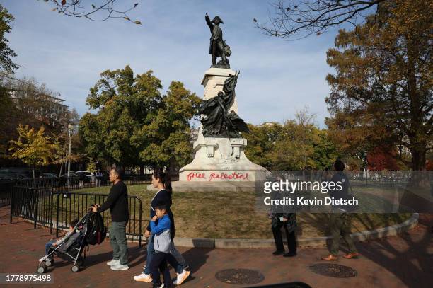 Pro-Palestinian graffiti is seen on a statue of Major General Comte Jean de Rochambeau in Lafayette Park near the White House on November 06, 2023 in...
