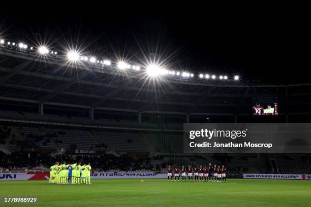 Players and officials observe a minute's silence for the victims of the recent flooding in the Tuscany region of Italy, prior to kick off in the...