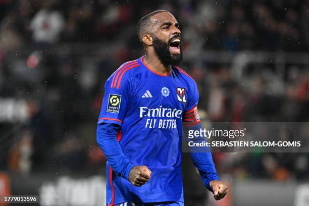Lyon's French forward Alexandre Lacazette celebrates after winning their first match of the season after the French L1 football match between Stade...