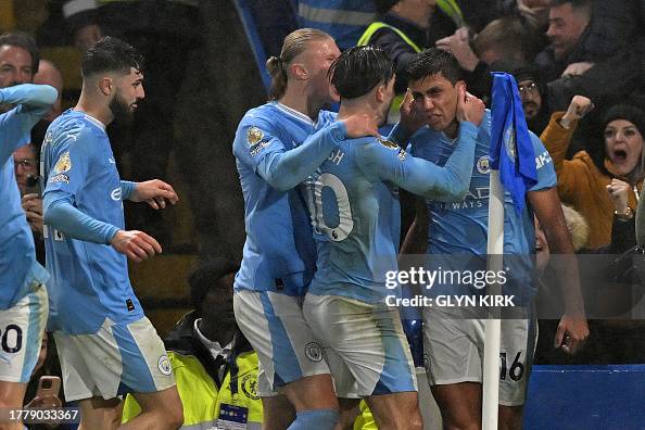 Manchester City's Spanish midfielder Rodri celebrates with teammates