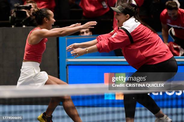 Canada's Leylah Fernandez celebrates with Canada's captain Heidi El Tabakh after beating Italy's Jasmine Paolini during the final singles tennis...