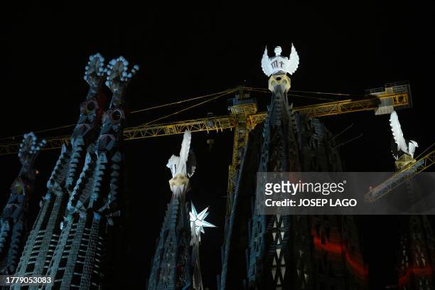 The Sagrada Familia basilica's towers of the Evangelists are lit up for the first time, following a blessing ceremony, marking their completion, on...