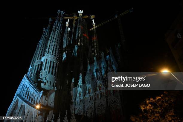 The Sagrada Familia basilica's towers of the Evangelists are lit up for the first time, following a blessing ceremony, marking their completion, on...