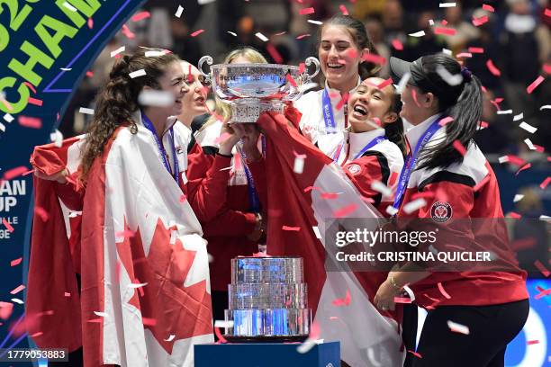 The members of team Canada hold their trophy as they celebrate on the podium after winning the Billie Jean King Cup Finals 2023 in La Cartuja stadium...