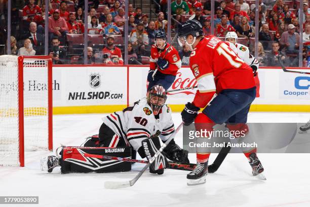 Goaltender Arvid Soderblom of the Chicago Blackhawks stops a shot by Anton Lundell of the Florida Panthers during first period action at the Amerant...