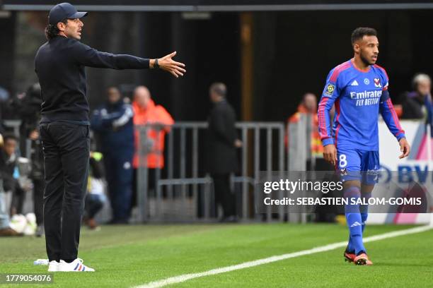 Lyon's Italian head coach Fabio Grosso gestures near Lyon's French midfielder Corentin Tolisso during the French L1 football match between Stade...