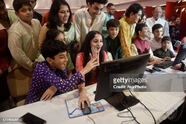 Children of a stockbroker family reacts as they watch a terminal during a special ''muhurat'' trading session for Diwali, the Hindu festival of...