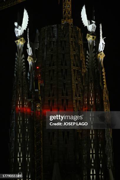 The pinnacles of the Sagrada Familia basilica's four towers of the Evangelists are lit up for the first time, following a blessing ceremony, marking...